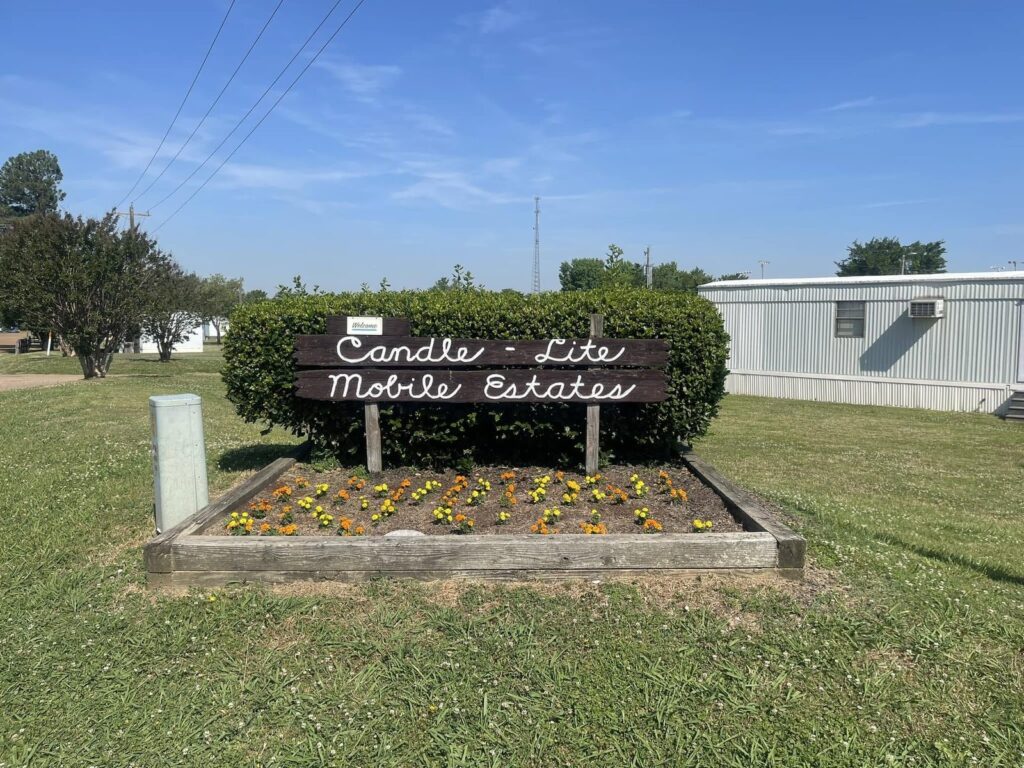 Candlelite Mobile Estates entrance sign with flower bed in Olive Branch, MS