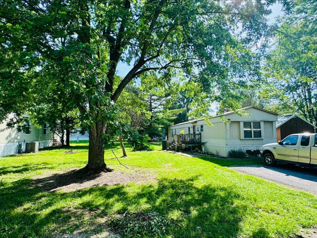 Manufactured home on a shaded lot at Prospect Mobile Home Community, Aurora, MO